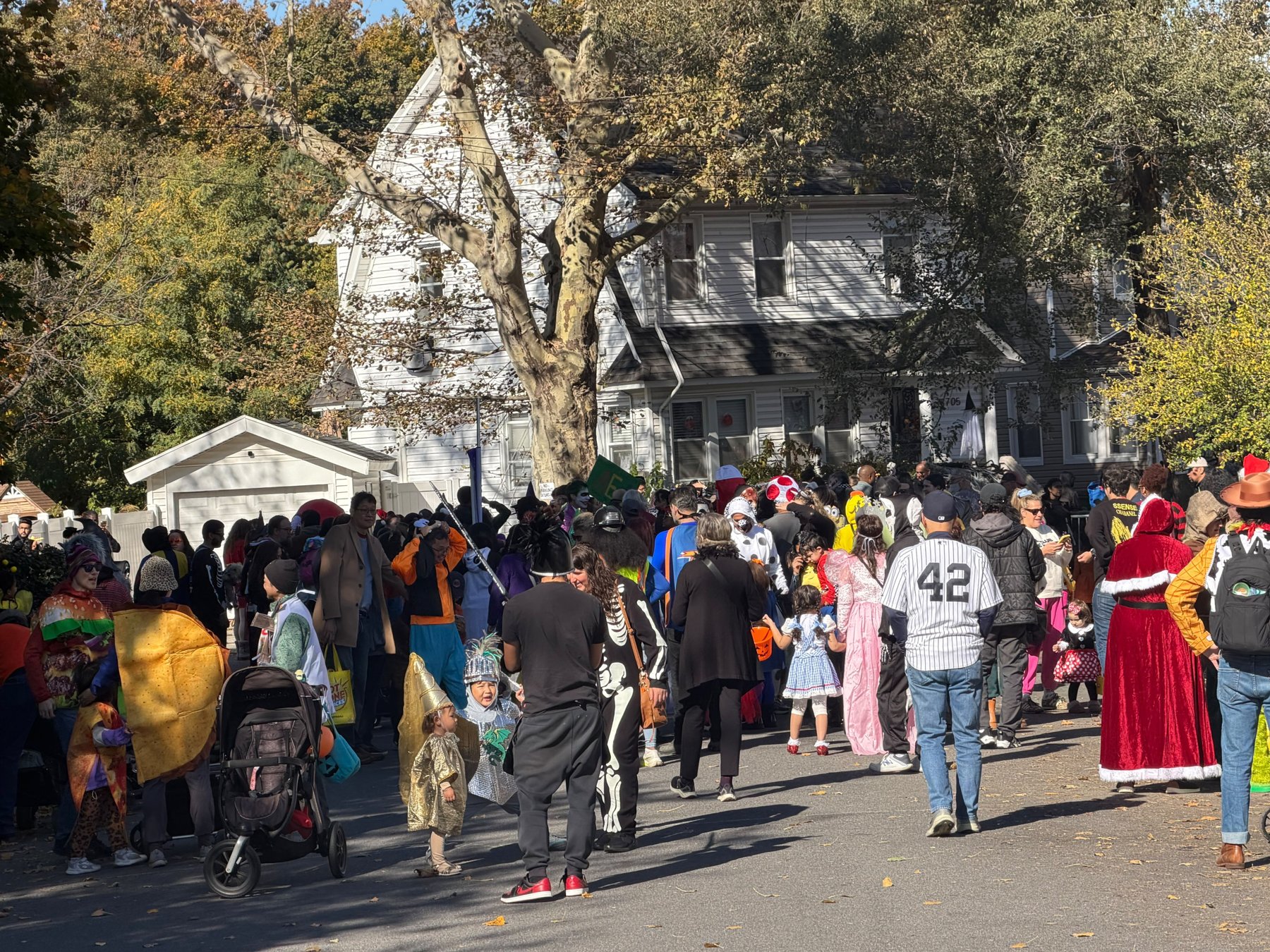 Families in costume at the Halloween parade in Forest Hills